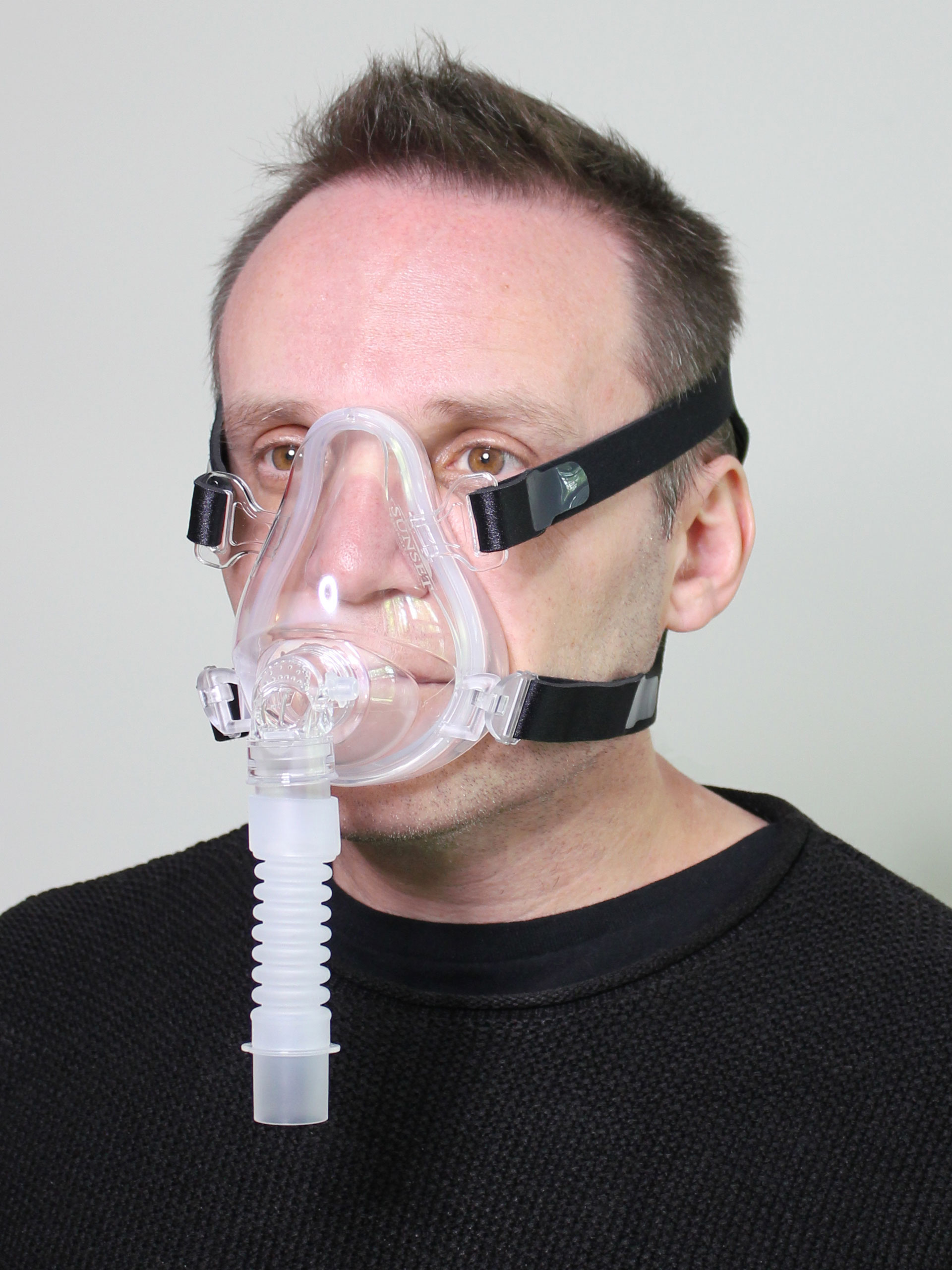 Photo of Sunset Deluxe Full Face CPAP mask in use (on male model)