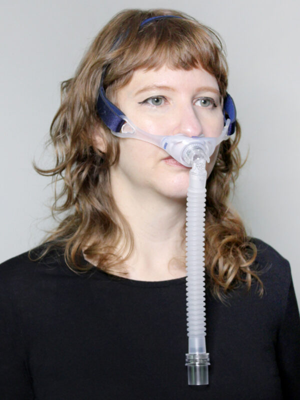 Photograph of Deluxe Nasal Pillow CPAP mask in use (on female model)