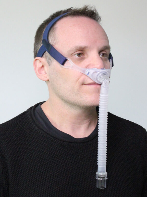 Photograph of Deluxe Nasal Pillow CPAP mask in use (on male model)