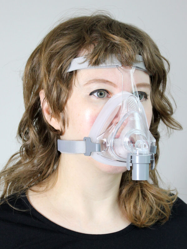 A woman wearing the Sol Full Face CPAP Mask