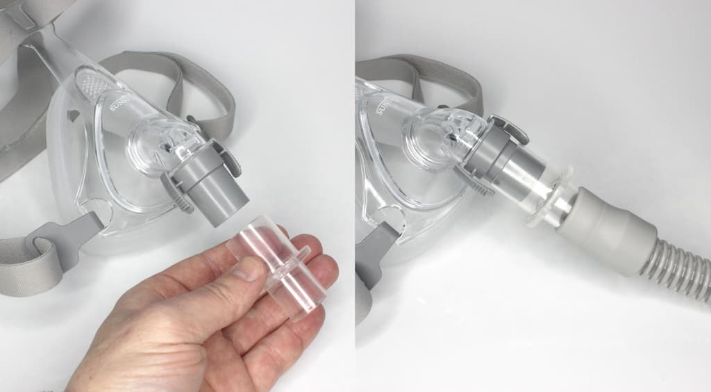 A photograph of a user attaching CAP1026 SleepRes V-Com to a CPAP mask
