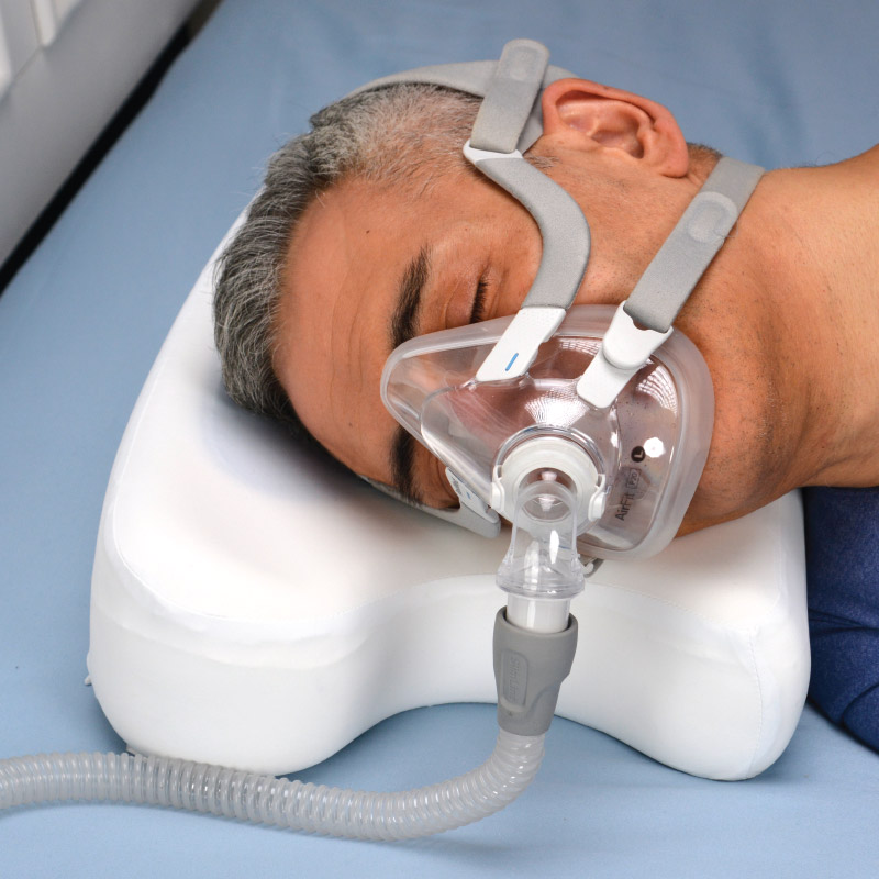 Photo of patient using CPAP Home & Travel Pillow and CPAP mask