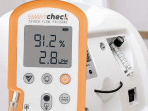 Photo of Smart Check analyzer being used to check a concentrator