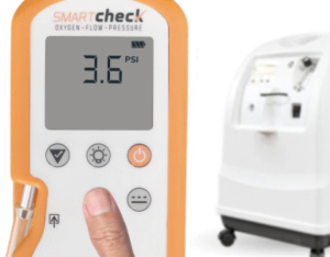 Photograph of Smart Check with a person's finger pressing a check button on the unit