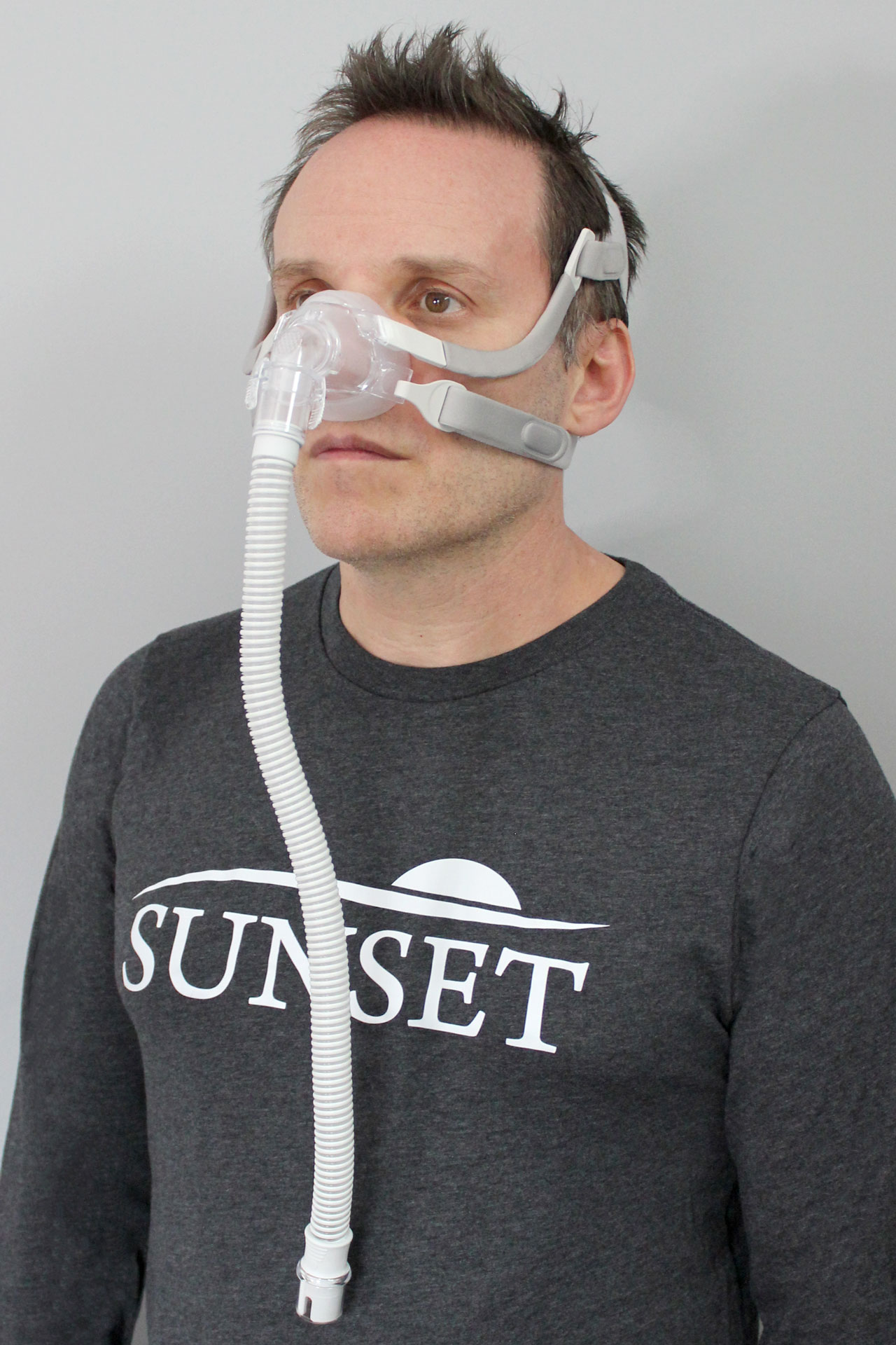 A man wearing the Sunset Vesper Nasal CPAP Mask