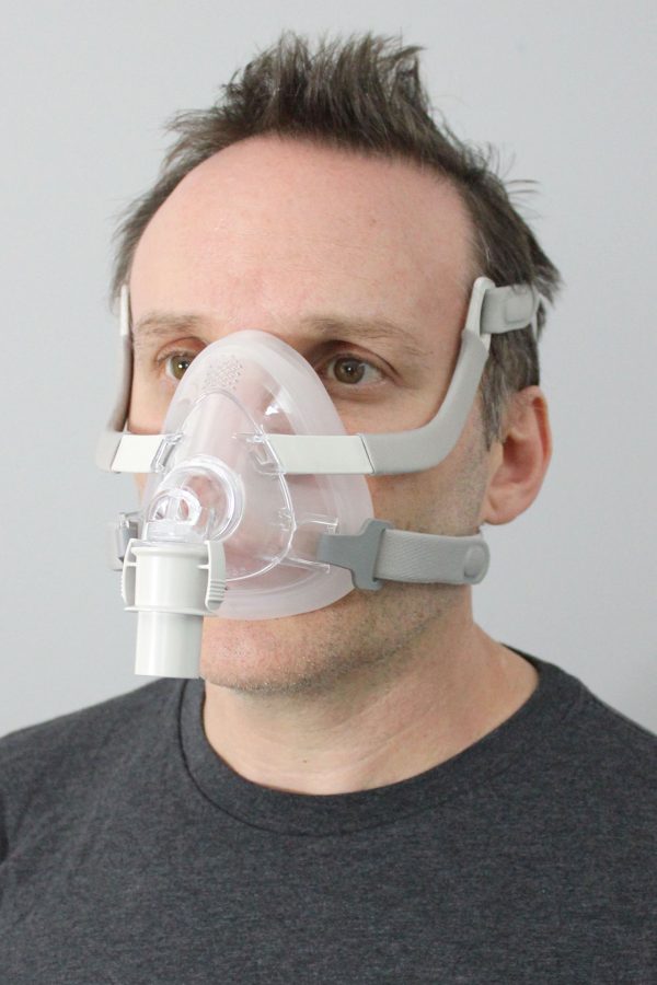 A man wearing the Sunset Vesper Full Face CPAP Mask